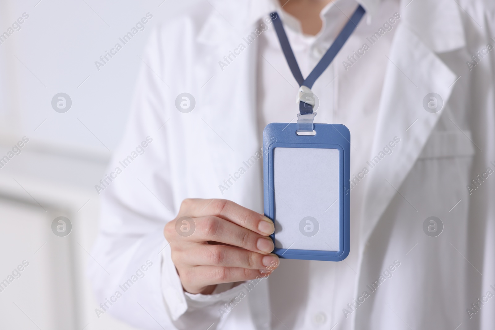 Photo of Doctor with badge in clinic, closeup view