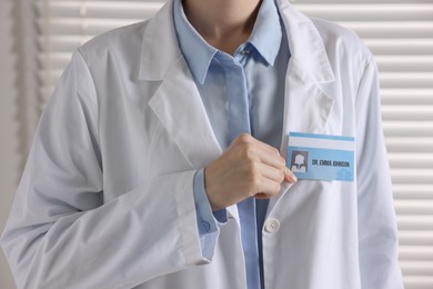 Photo of Doctor with badge in clinic, closeup view