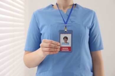 Photo of Medical assistant with badge in clinic, closeup