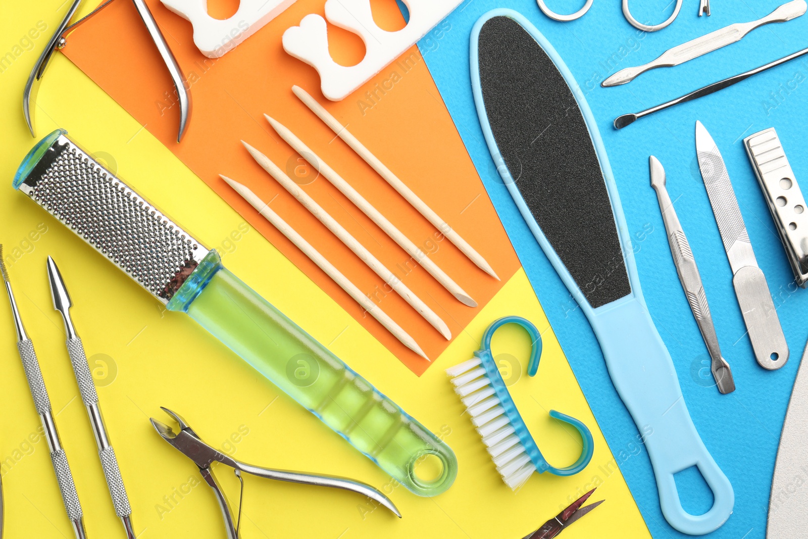 Photo of Set of pedicure tools on color background, flat lay