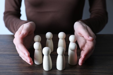 Photo of Human resources concept. Woman with wooden pieces at table, closeup