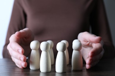 Photo of Human resources concept. Woman with wooden pieces at table, closeup