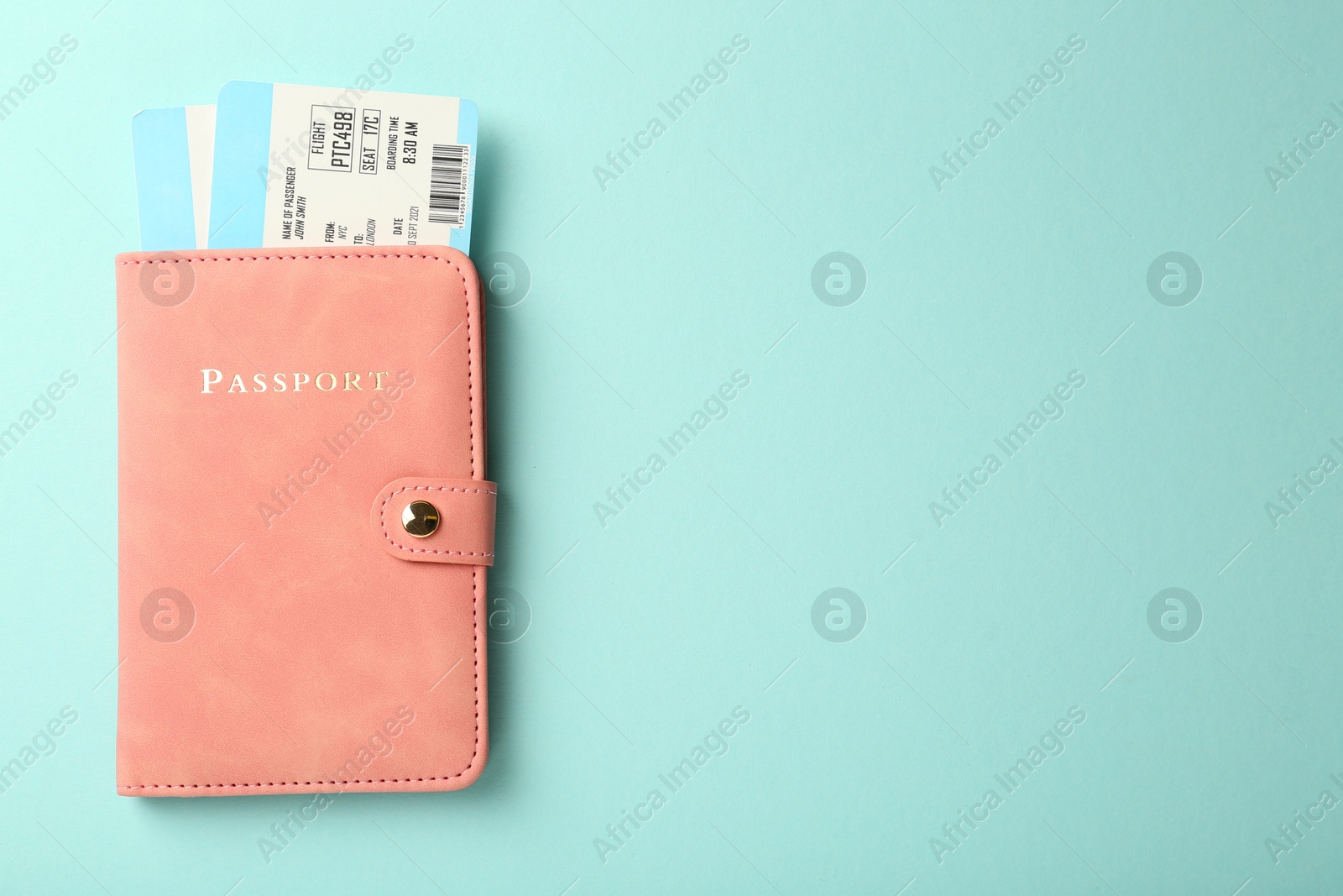 Photo of Passport with tickets on light blue background, top view. Space for text