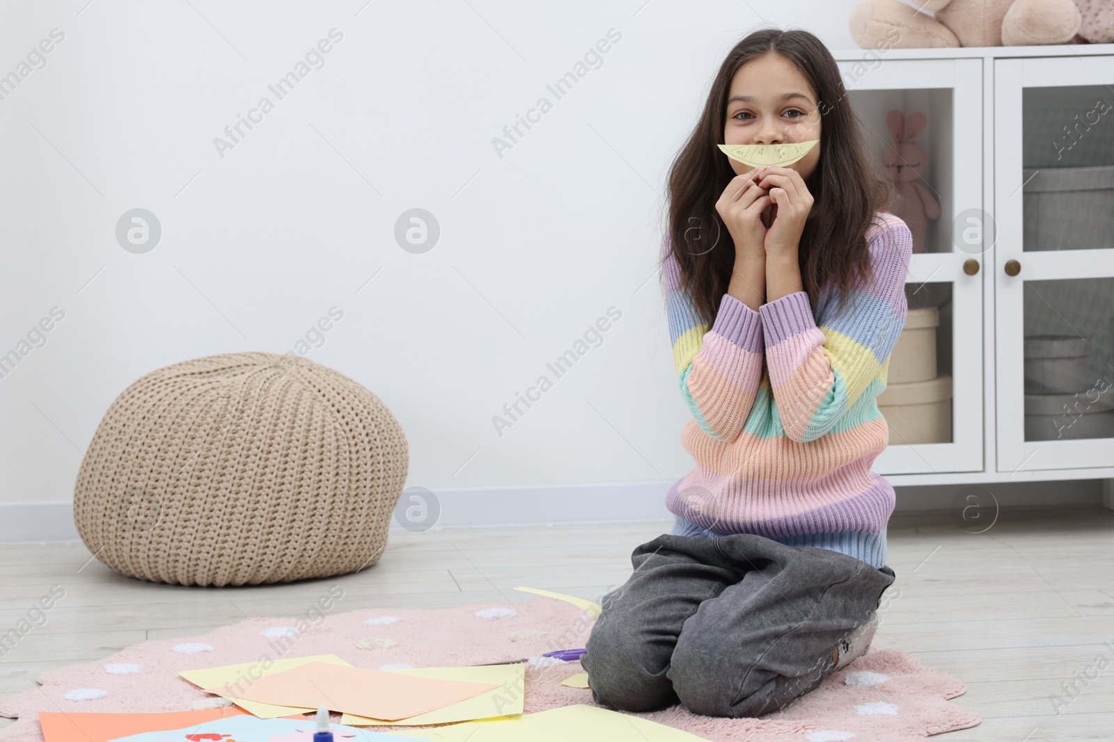 Photo of Girl making art project at home. Space for text