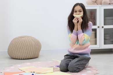 Photo of Girl making art project at home. Space for text