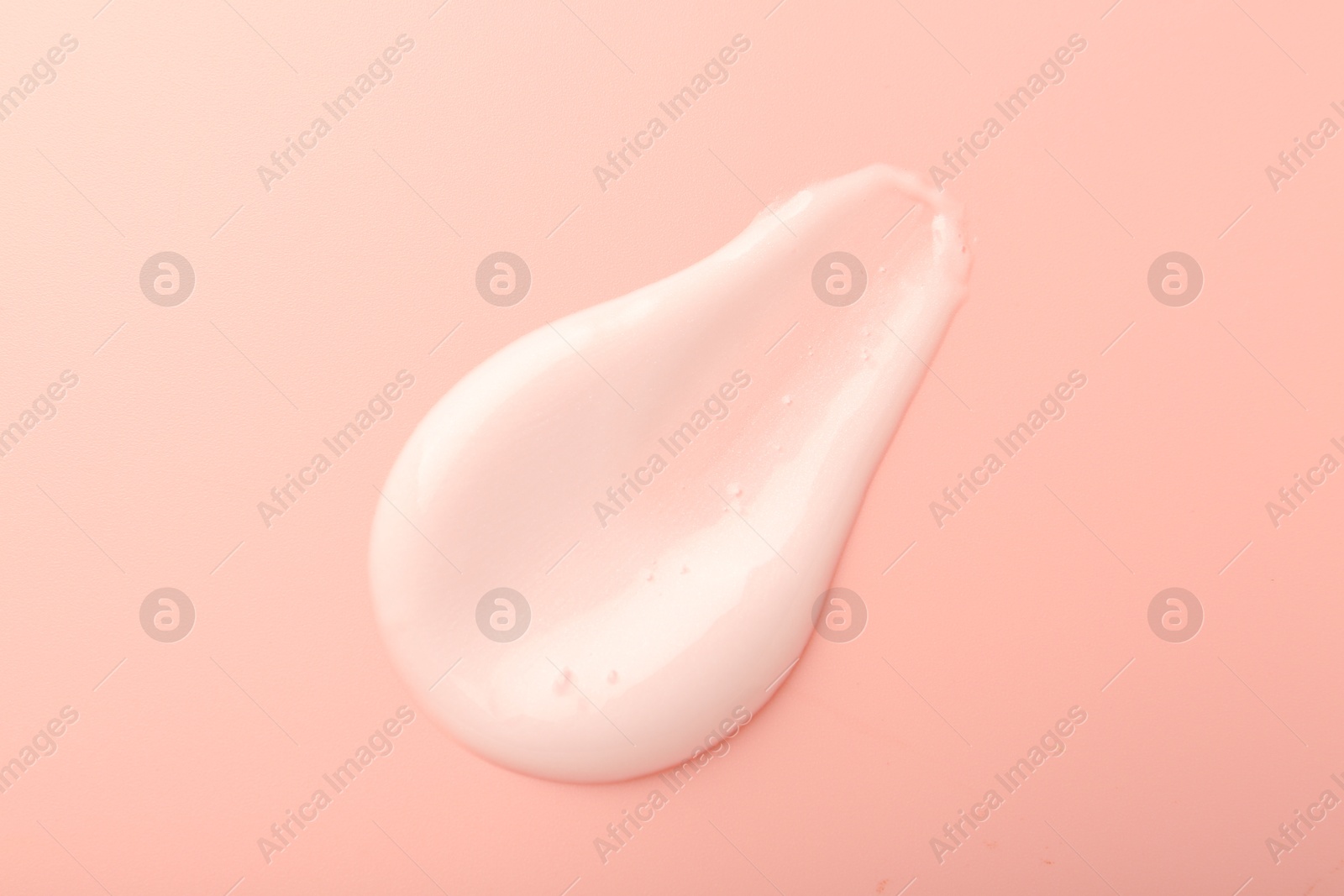 Photo of Cream sample on pink background, top view