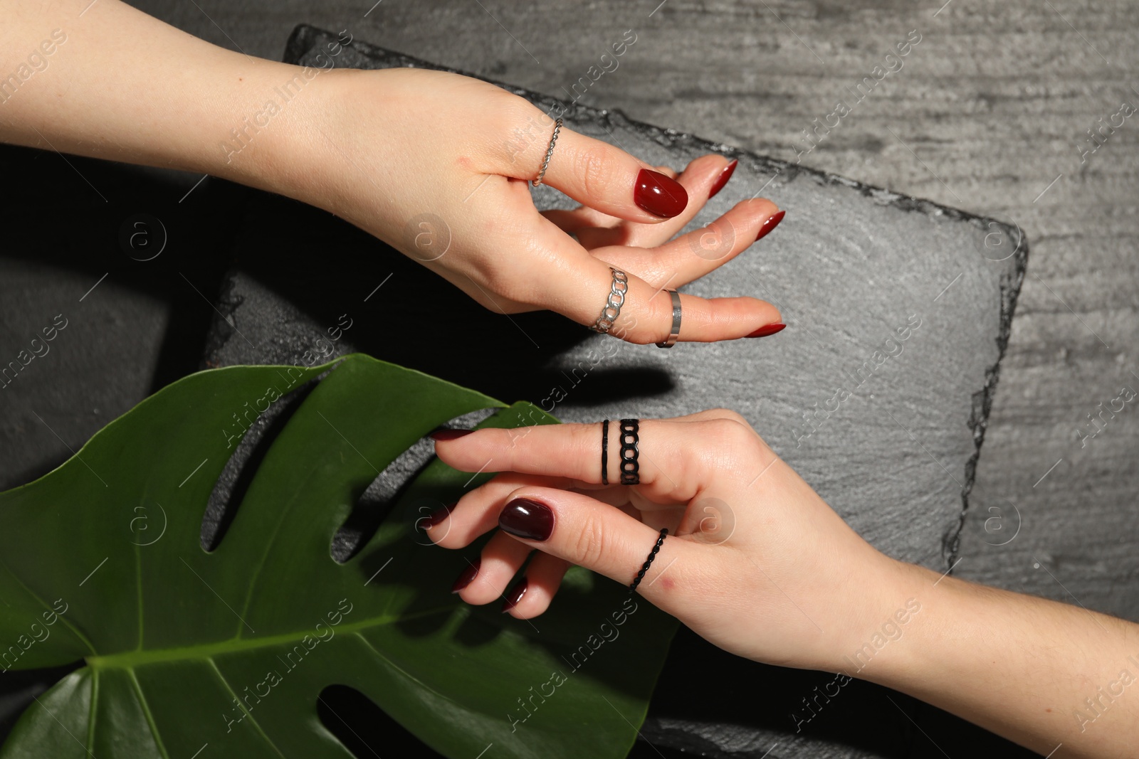 Photo of Women wearing beautiful rings on black background, closeup