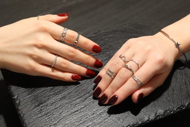 Photo of Women wearing beautiful rings on black background, closeup