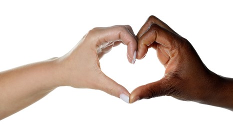 Photo of Stop racism. People of different skin colors making heart with hands on white background, closeup