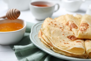 Photo of Delicious crepes served on white table, closeup