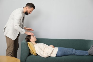 Photo of Psychologist working with patient during hypnosis session indoors