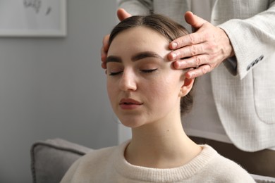 Photo of Psychologist working with patient during hypnosis session indoors, closeup. Space for text