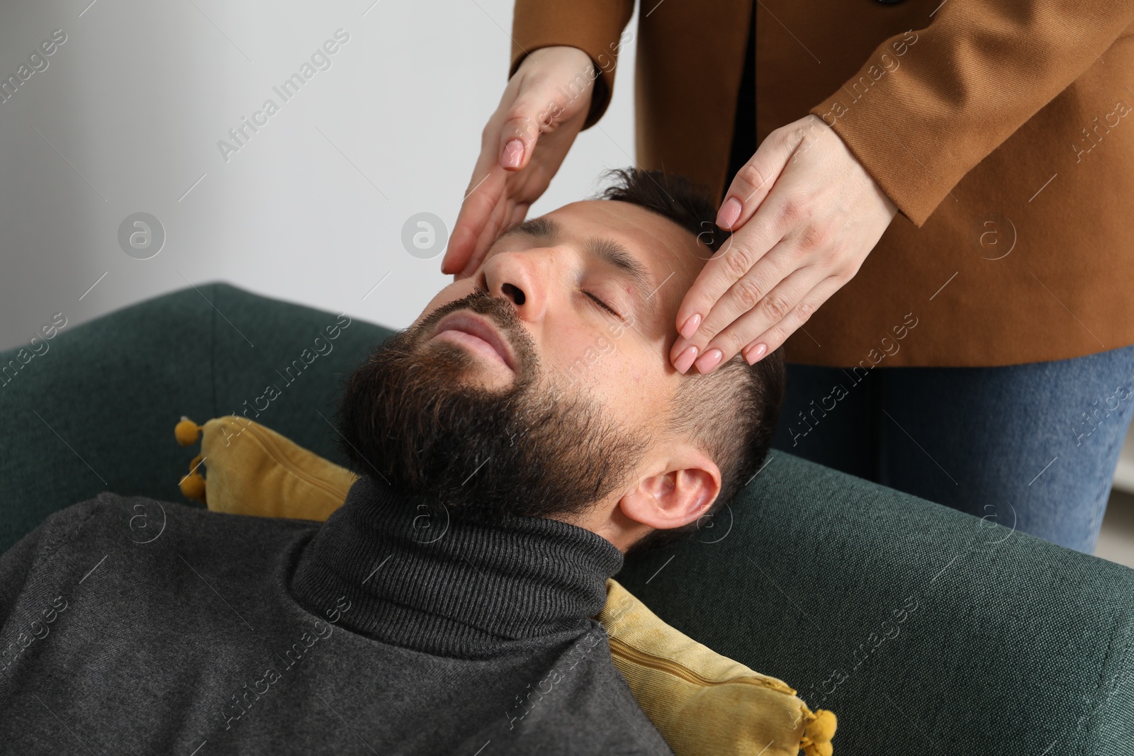 Photo of Psychologist working with patient during hypnosis session indoors, closeup