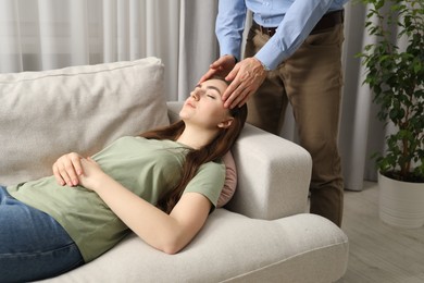 Photo of Psychologist working with patient during hypnosis session indoors, closeup