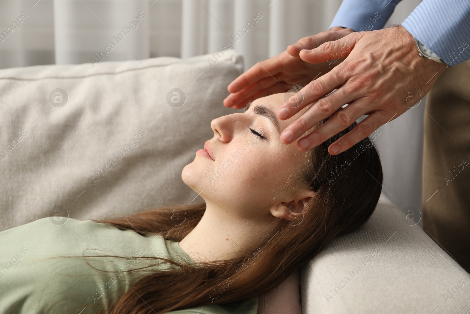 Photo of Psychologist working with patient during hypnosis session indoors, closeup