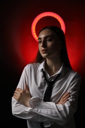 Photo of Beautiful woman with ring lamp on dark red background