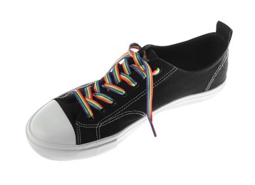 Photo of Black shoe with bright rainbow lace on white background. LGBT concept