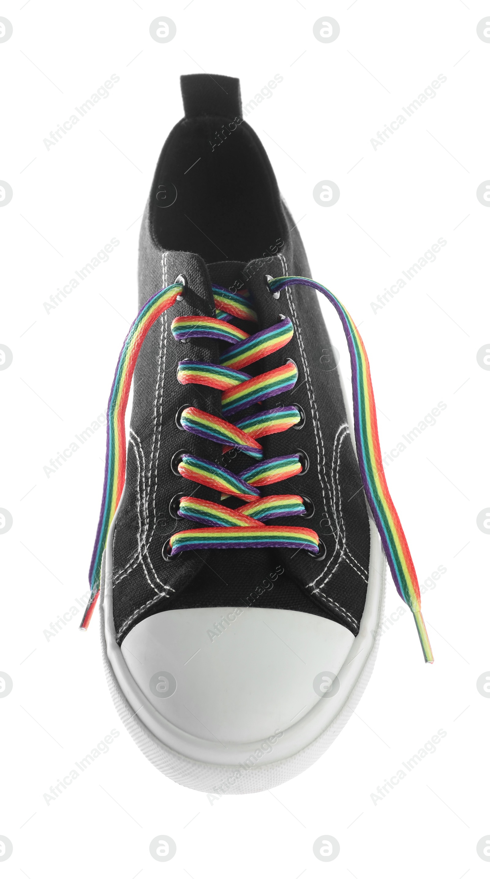 Photo of Black shoe with bright rainbow lace on white background, above view. LGBT concept