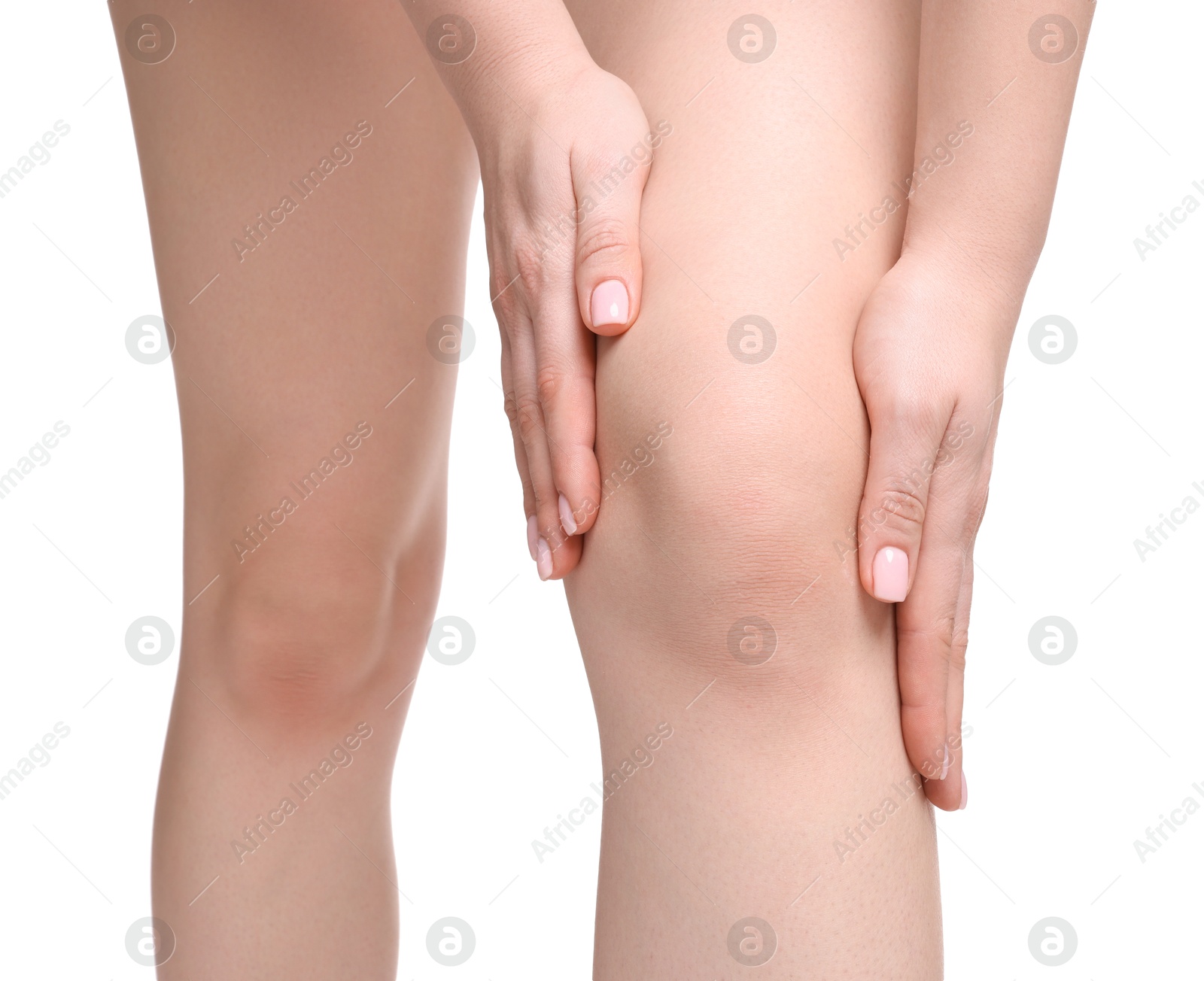 Photo of Young woman suffering from pain in knee on white background, closeup