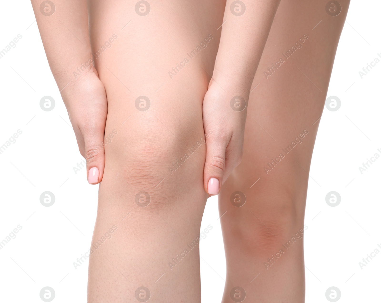 Photo of Young woman suffering from pain in knee on white background, closeup