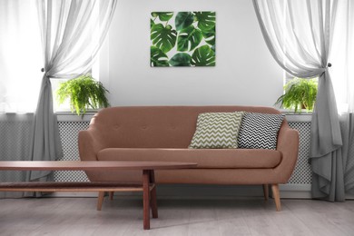 Image of Sofa in mocha mousse shade and decor indoors. Interior with trendy color of 2025 year