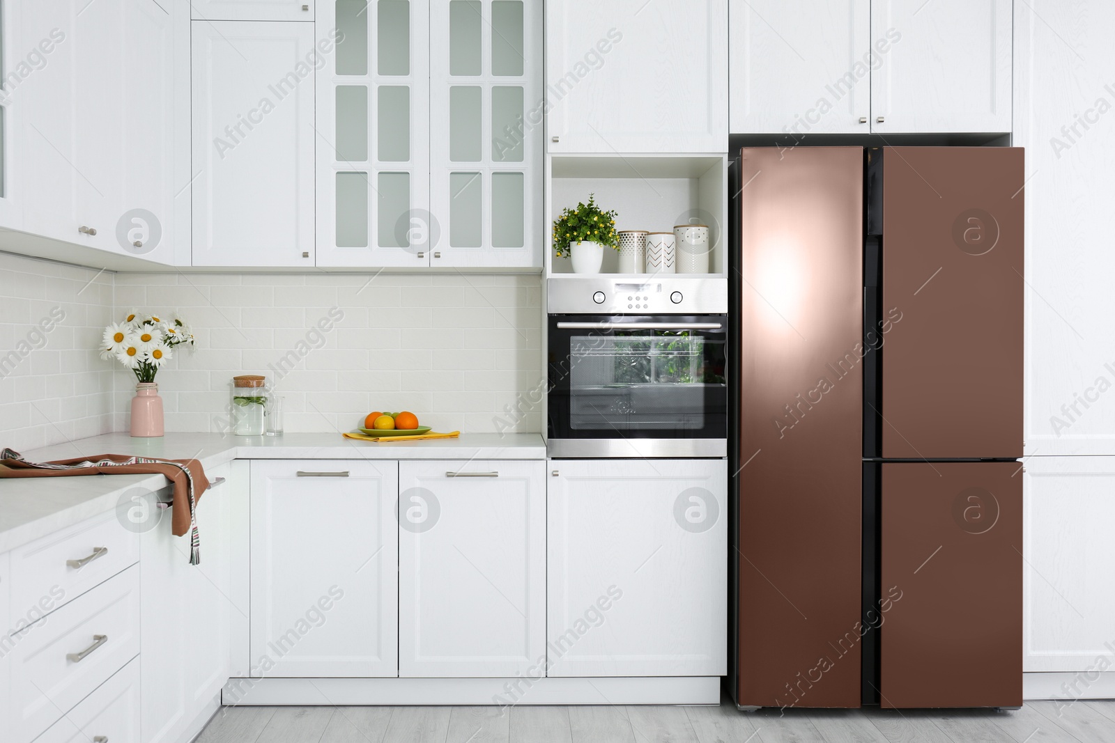 Image of Fridge in mocha mousse shade and other furniture indoors. Kitchen interior with trendy color of 2025 year