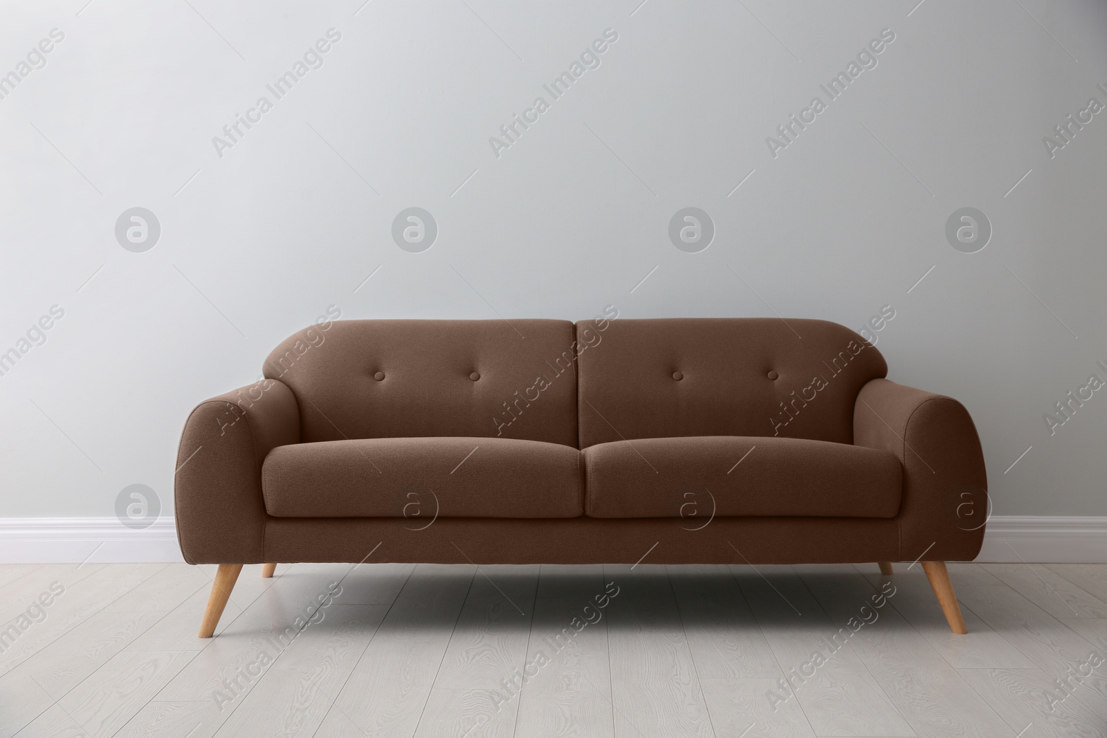 Image of Sofa in mocha mousse shade indoors. Interior with trendy color of 2025 year