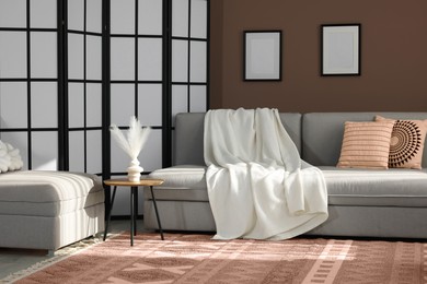 Image of Cozy living room interior in mocha mousse shade. Brown wall and dark beige carpet. Trendy color of 2025 year