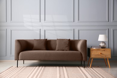 Image of Sofa in mocha mousse shade indoors. Cozy interior with trendy color of 2025 year