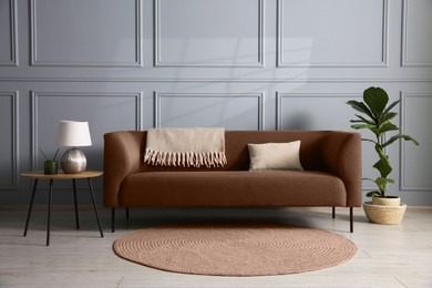 Image of Sofa in mocha mousse shade indoors. Cozy interior with trendy color of 2025 year