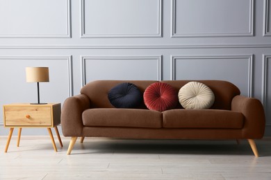 Image of Sofa in mocha mousse shade indoors. Interior with trendy color of 2025 year