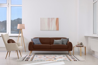 Image of Sofa in mocha mousse shade and other furniture indoors. Interior with trendy color of 2025 year