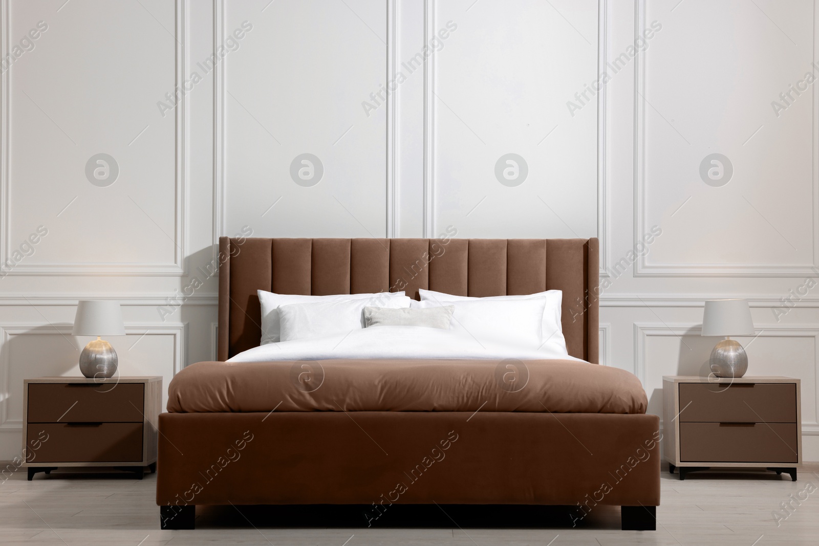 Image of Large bed in mocha mousse shade and nightstands indoors. Trendy color of 2025 year in interior design