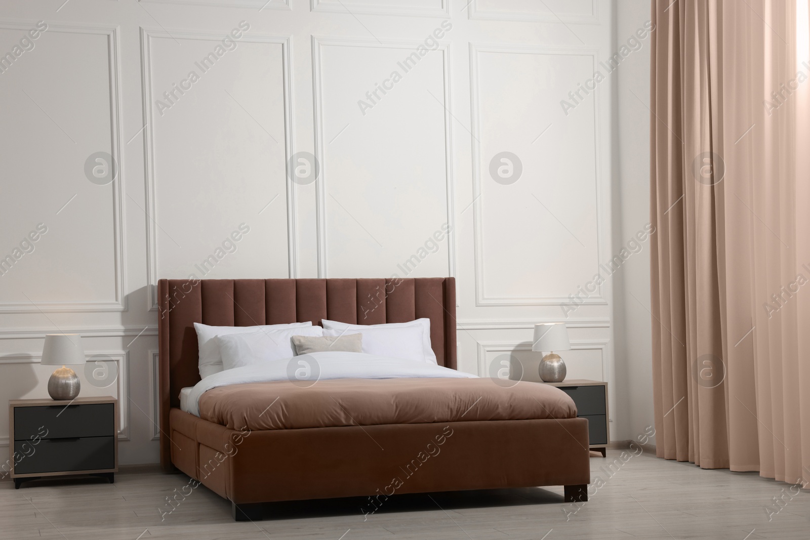 Image of Large bed in mocha mousse shade and nightstands indoors. Trendy color of 2025 year in interior design