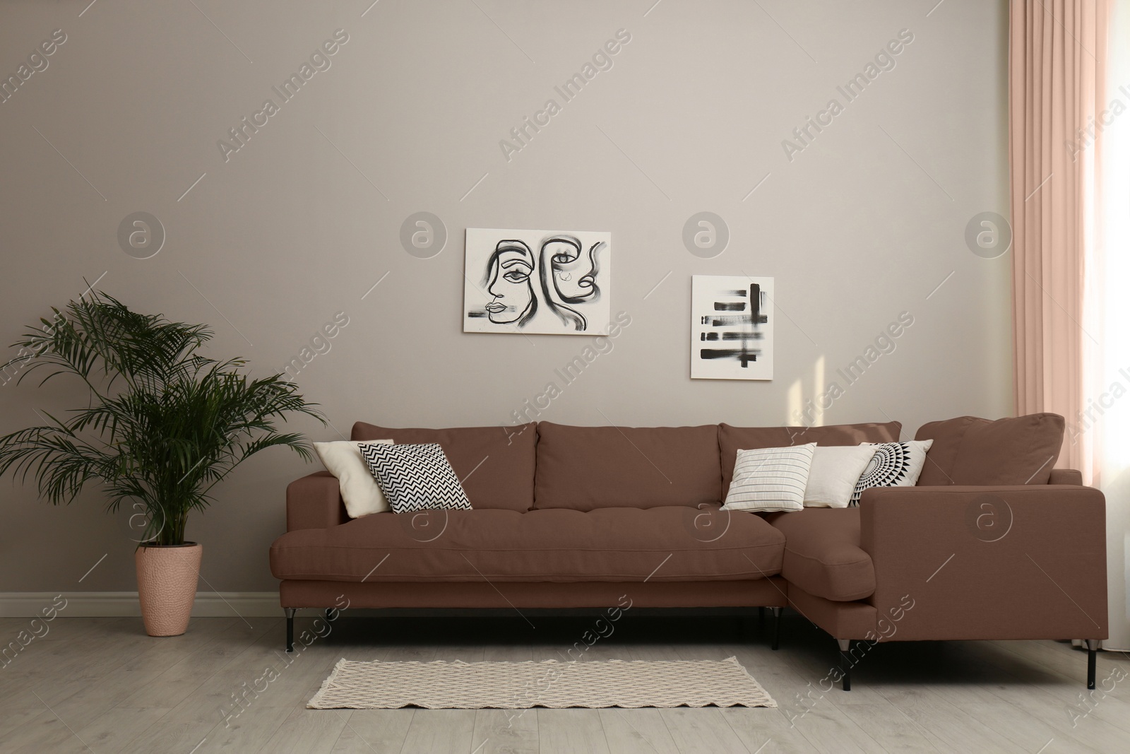 Image of Sofa in mocha mousse shade and decor indoors. Interior with trendy color of 2025 year