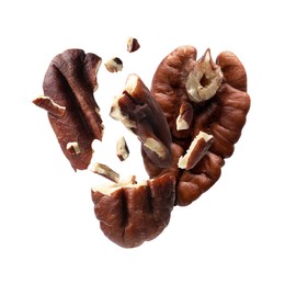 Image of Broken pecan nuts in air on white background