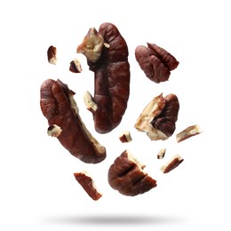 Image of Broken pecan nuts in air on white background