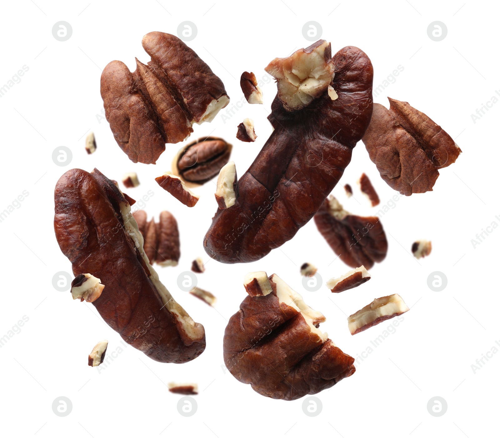 Image of Broken pecan nuts in air on white background