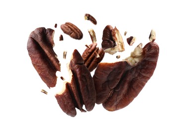 Image of Broken pecan nuts in air on white background