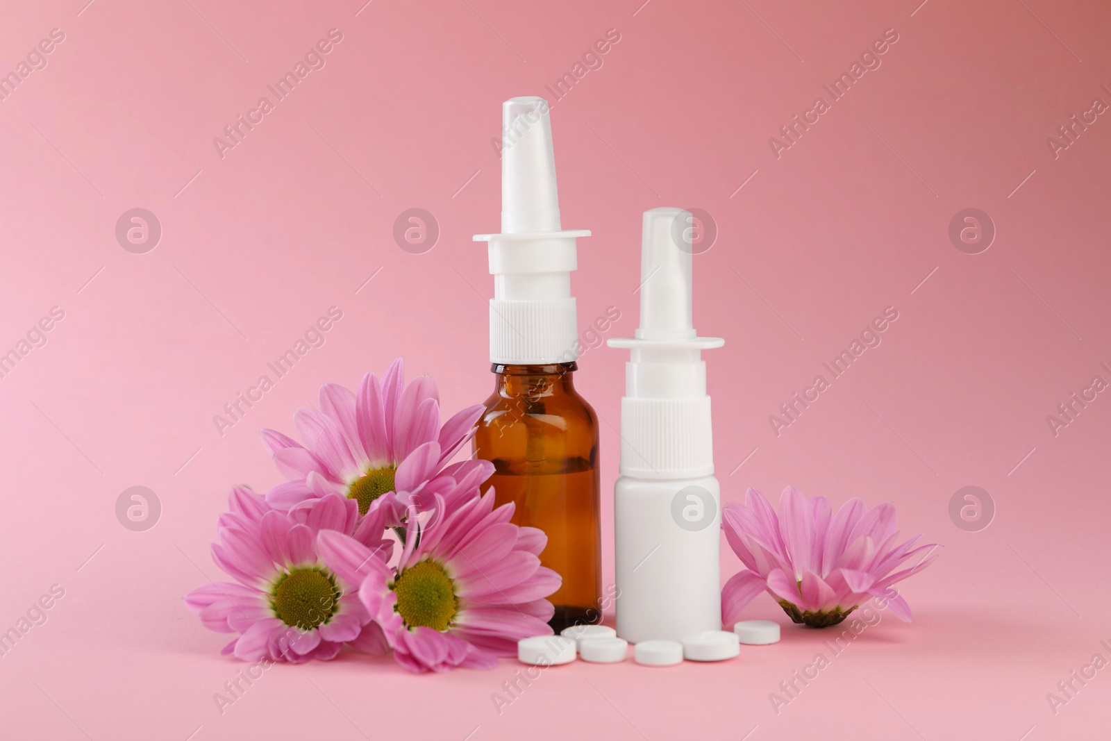 Photo of Allergy treatment. Different medications and flowers on pink background