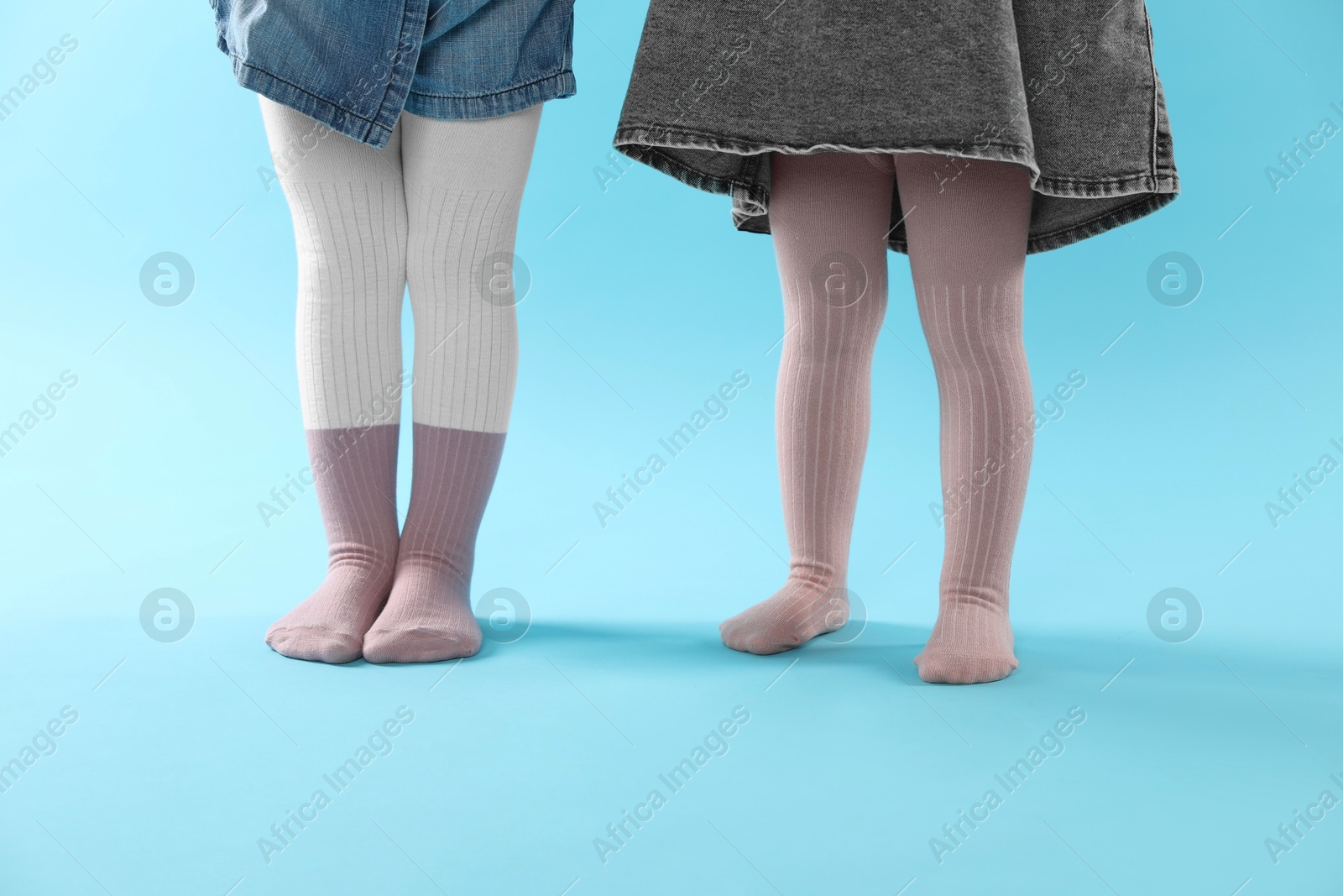 Photo of Kids wearing tights on light blue background, closeup