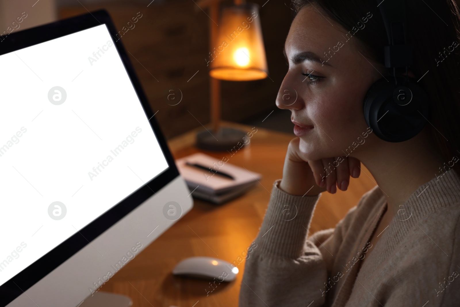 Photo of Woman working on computer at wooden table in office