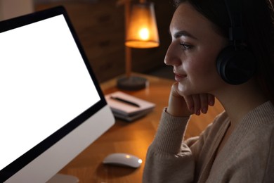 Photo of Woman working on computer at wooden table in office