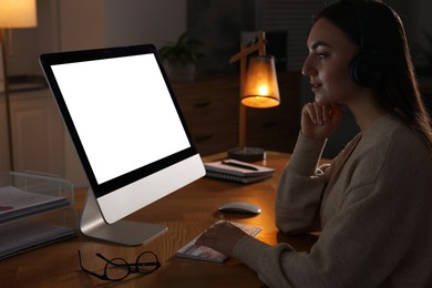 Photo of Woman working on computer at wooden table in office