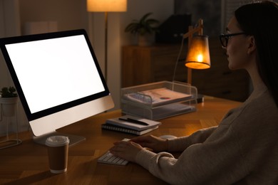 Photo of Woman working on computer at wooden table in office