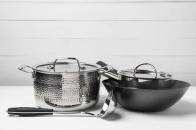 Photo of Dishware and cooking utensils on white table