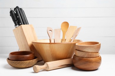 Photo of Dishware and cooking utensils on white table