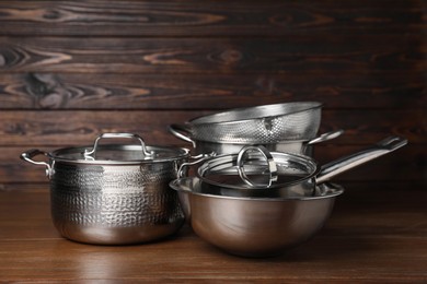 Photo of Dishware and cooking utensils on wooden table