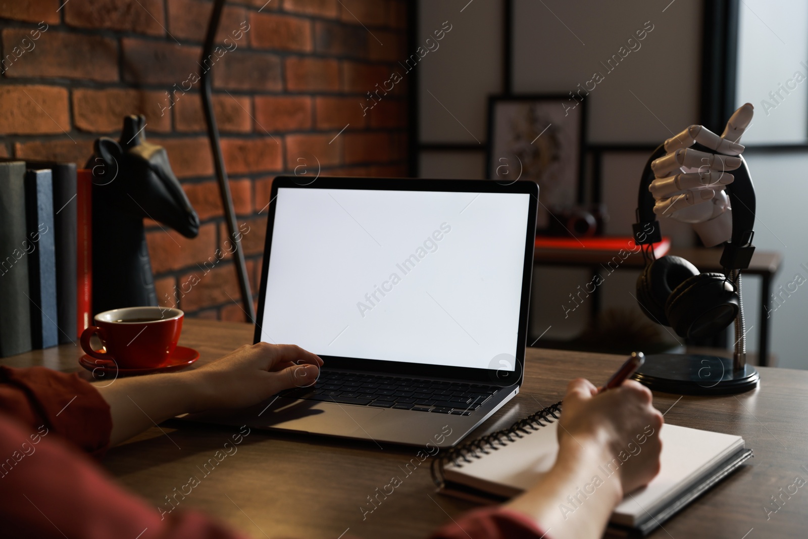 Photo of Woman working with laptop at table in office, closeup