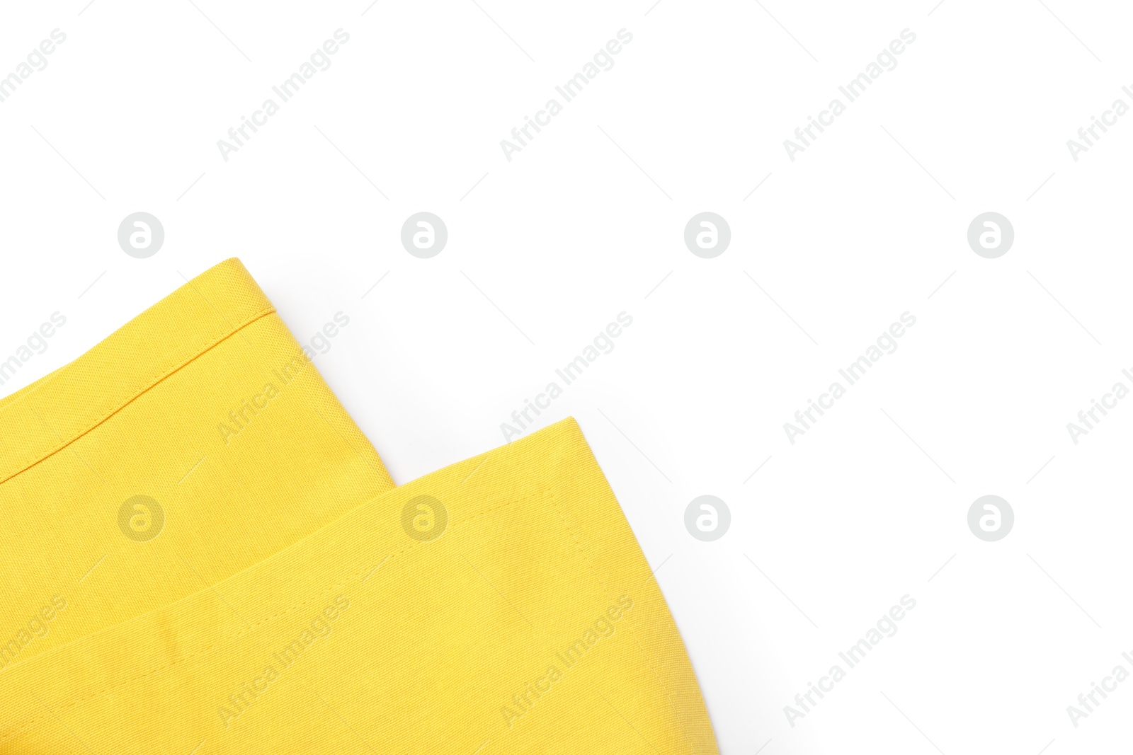 Photo of Yellow tablecloth isolated on white, top view